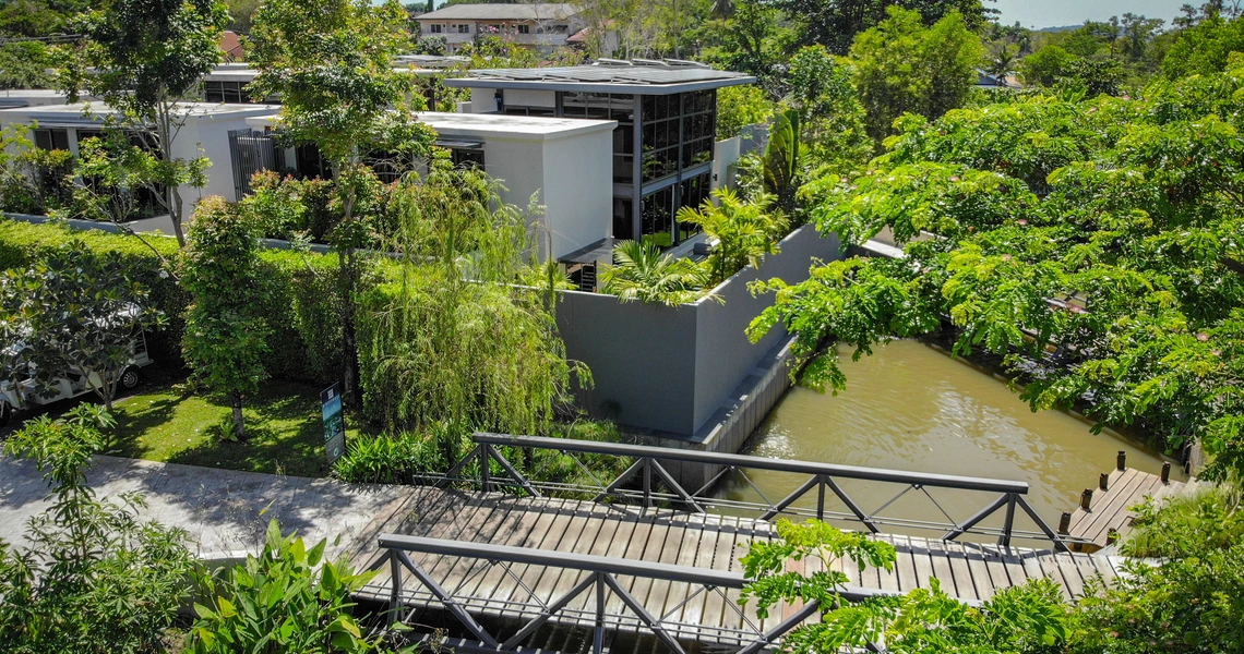 Riverhouse Phuket villas canal with a bridge