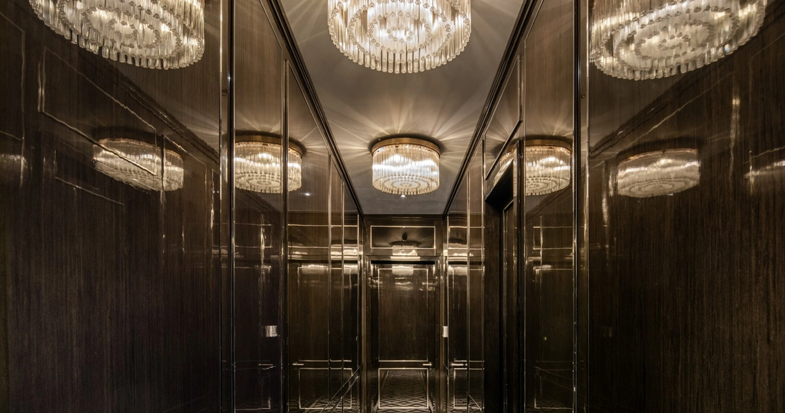 The Ritz-Carlton Residences Bangkok - dark wood paneling and mirrors in a hallway